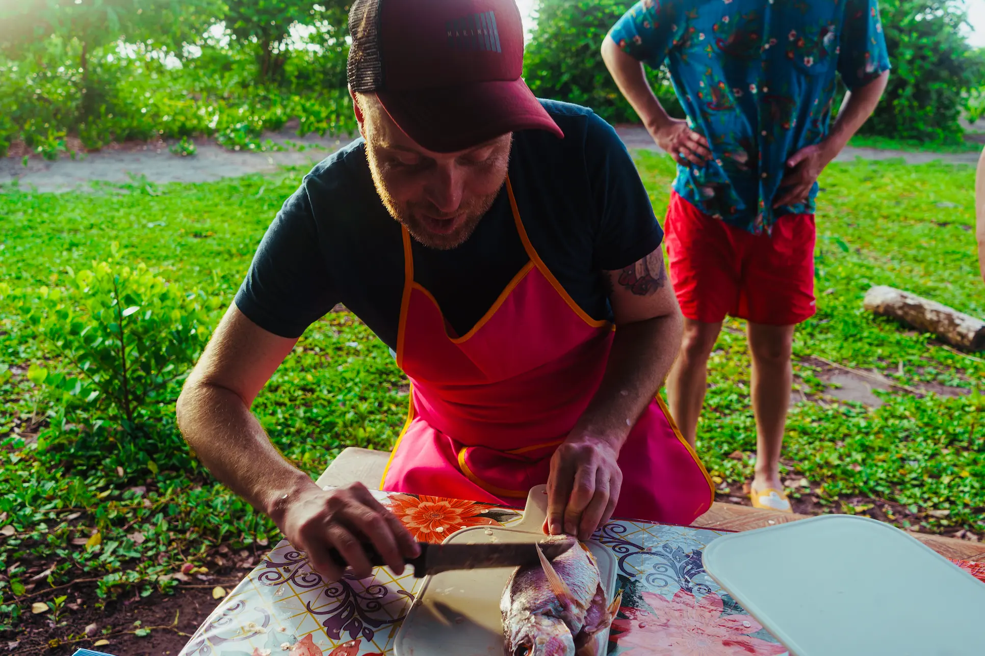 Traveller preparing fresh fish during the traditional cooking experience in Tumaco