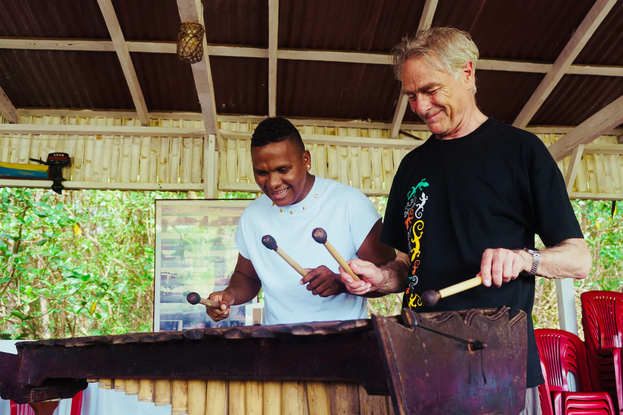 Traveller learning to play the marimba with a Tumaco musician