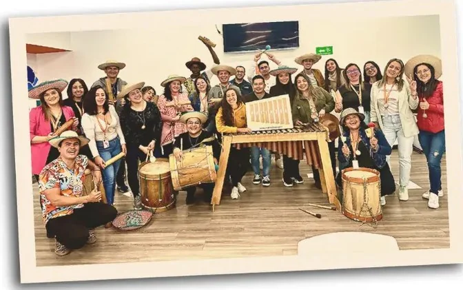 Company team celebrating with marimba, drums and hats during a Marimbea cultural experience