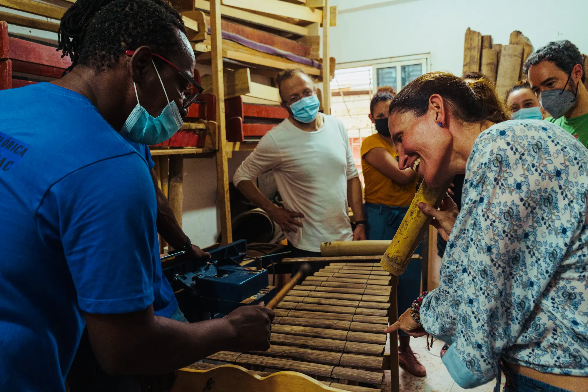 Travellers trying out marimba resonators during the instrument building workshop in Tumaco