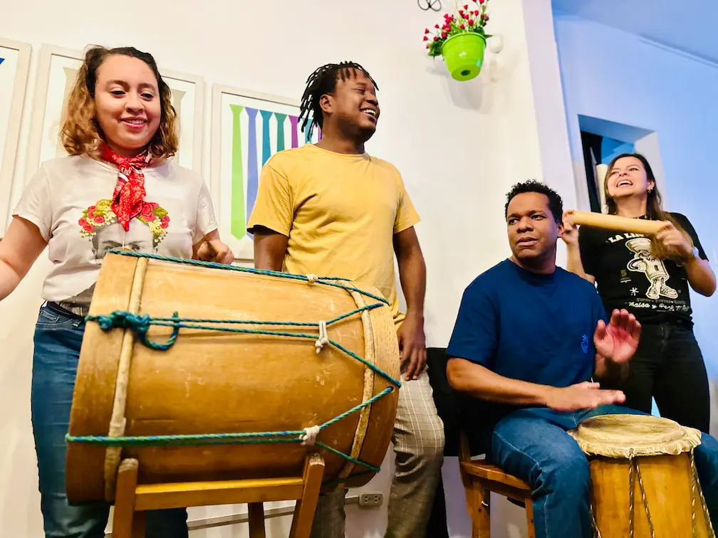 People learning percussion with drums at a Marimbea workshop