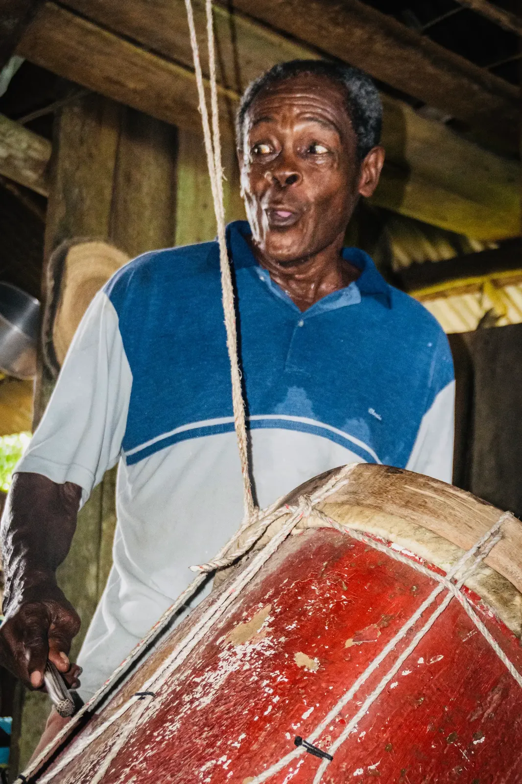 Pacho Torres playing the bombo drum during a music session in Guapi